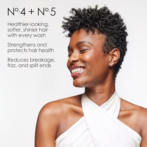 Woman with curly hair smiling, promoting hair care benefits