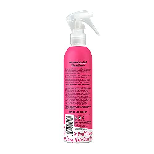 Pink hair product spray bottle with text on label