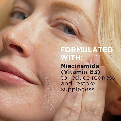 Woman applying skincare product with niacinamide to her face.